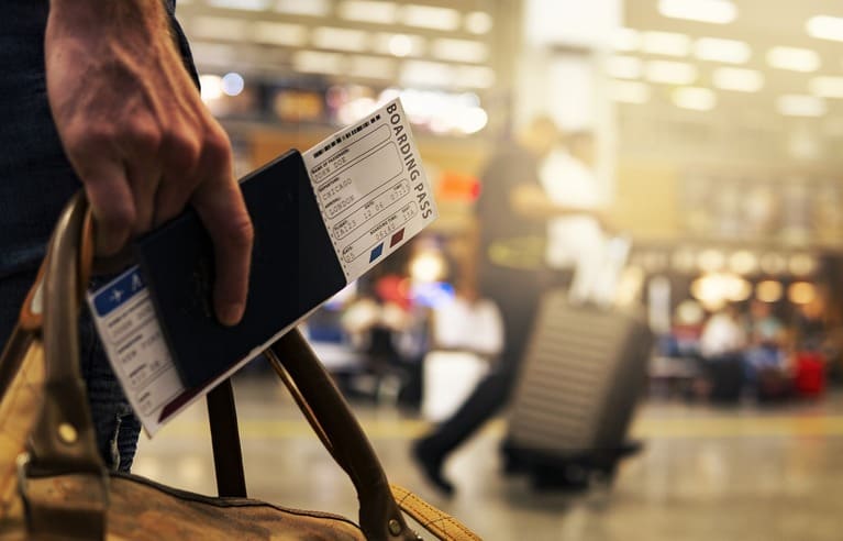 Picture of a passport and the Boarding pass for a ship crew member waiting to board a plane.