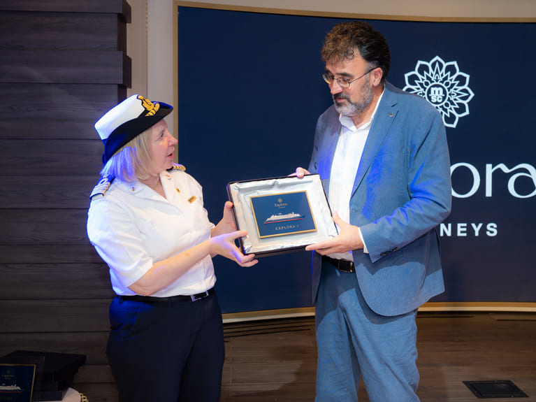 Captain Serena Melani, captain of the Explora I with Lluís Salvadó, the president of the Port of Barcelona. Exchanging the traditional crest. Local port officials of the barcelona port authority have welcomed the new ship Explora I