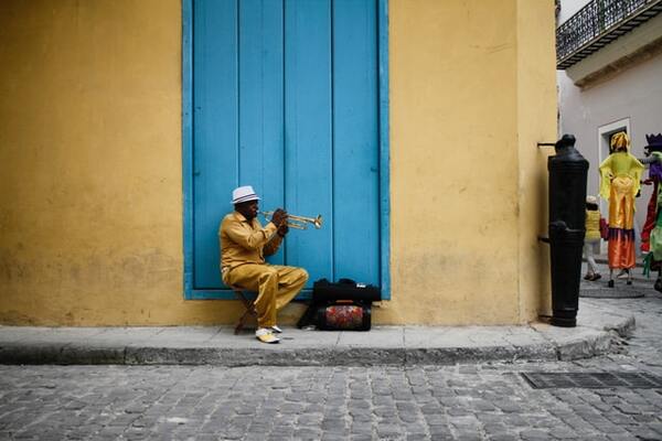Exploring the streets of Havana while MSC Armonia is in port - man sitting in the street playing the Saxophone | by Jessica Knowlden 600x400