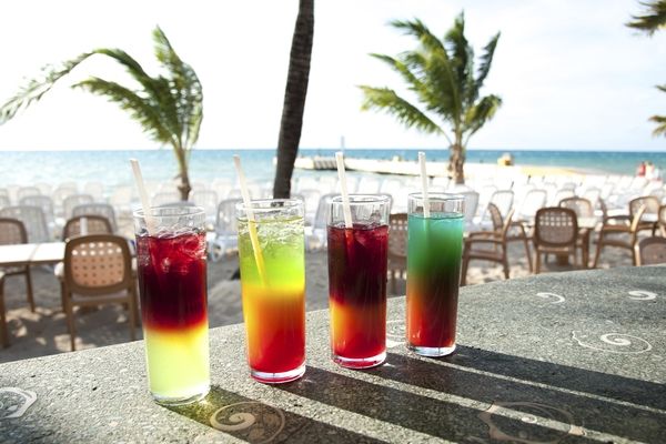 Four different cocktails on a beach in Cozumel, Mexico