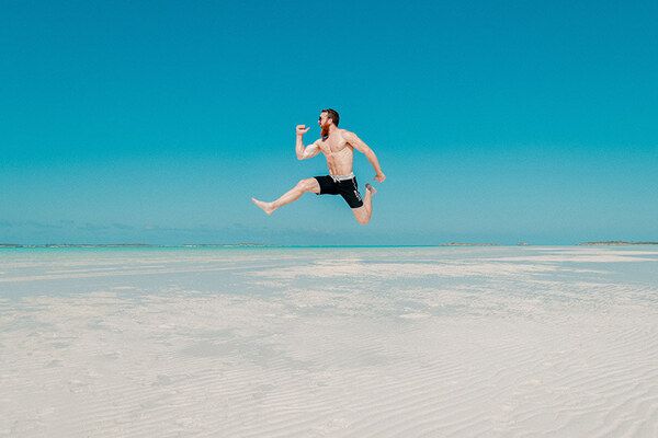 Gent jumping on a white beach | by Jakob Owens 600x400