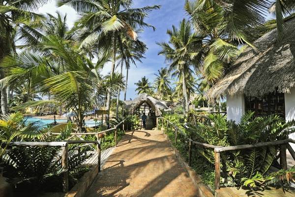 Enjoy an MSC Cruises to Mozambique - Walkway in the middle of buildings overseeing a pool