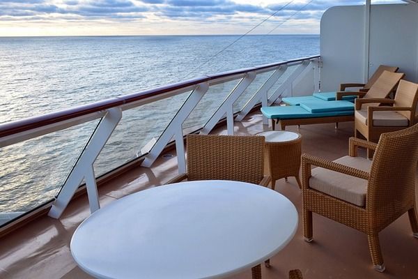 Stunning view from one of the Balcony cabins with chairs and view of the ocean