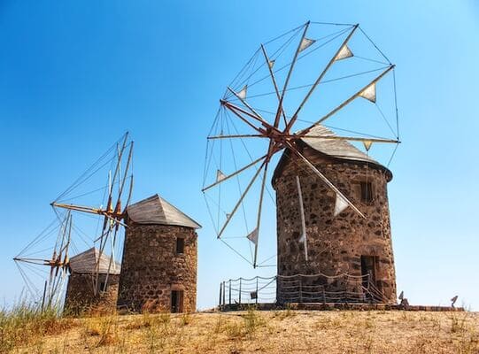 Windmill in Patmos, Greece. Whitewashed windmill on a hilltop overlooking the Aegean Sea. Patmos Island, Dodecanese Islands, Mediterranean Sea.