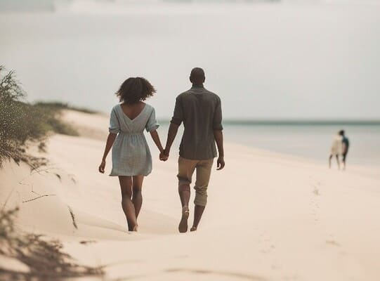 Couple walking on Pomene, Mozambique beach on their cruise from Durban to Pomene