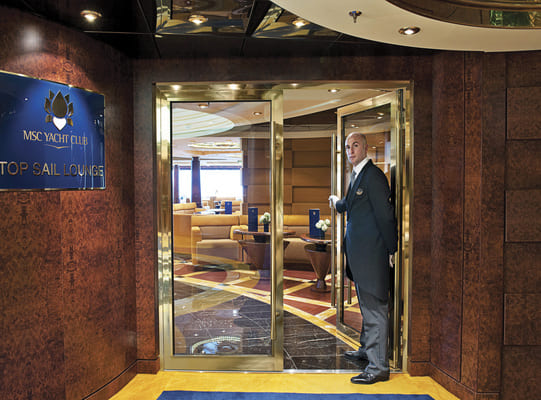 Butler opening the door of the MSC Yacht Club area on the MSC Splendida, 24 hour butler service is one of the many perks