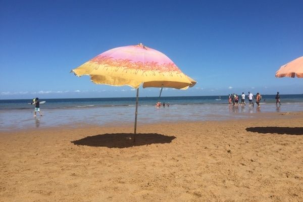 Yellow and pink umbrella on the beach of Portuguese Island in Mozambique on an MSC Cruises itinerary