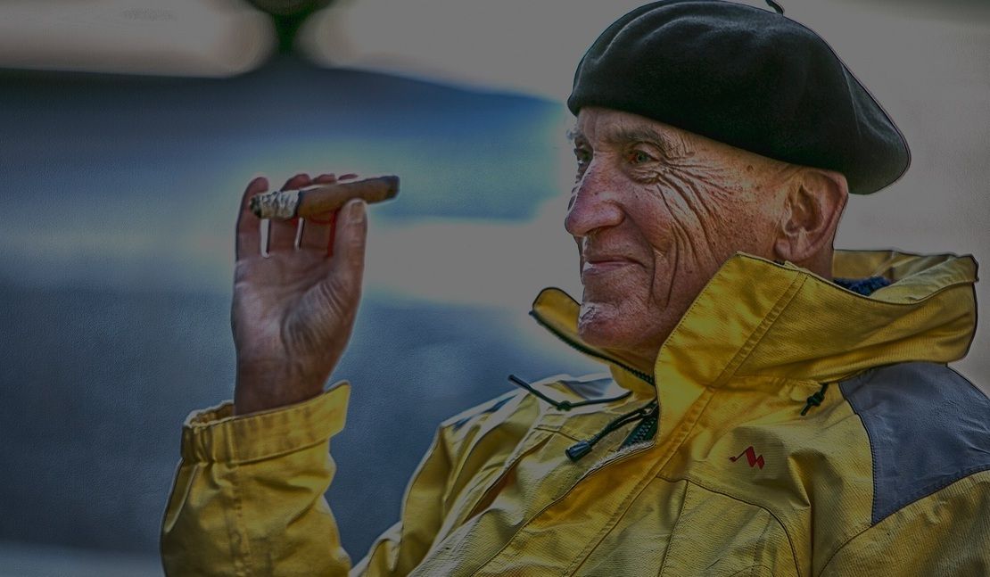 Man smoking a cigar on the deck of a cruise ship
