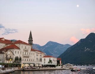Perast, Montenegro -  Adriatic Sea Charming town on the Bay of Kotor with red-tiled roofs, bell towers, clear blue waters, and two small islands.