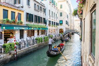 Gondolier taking a couple sightseeing in the Canal of Venice, Italy | 339x226 | by Dimitry Anikin