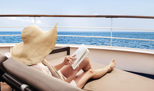 Lady relaxing on chair on a Silversea Classic cruise 540x320