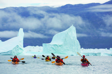Aurora Expeditions - Passengers canoeing in middle of glacier | by Michael Baynes-Rode 446x298