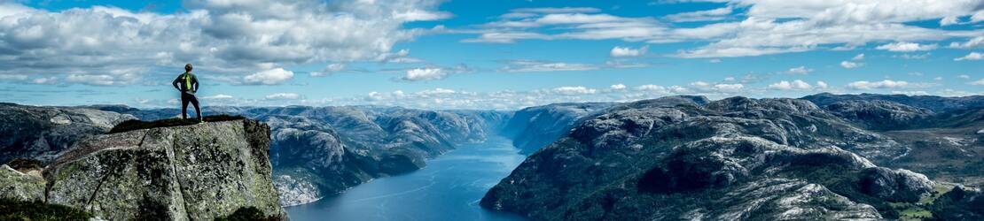 Man overlooking the Lysefjorden, Norway on a Cruise to Northern Europe | Carl Cerstrand | 1110x250