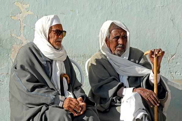 Two Bedouin Men sitting in Tunis, Tunisia looking | 600x400